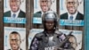 A Ugandan riot policeman blocks the gate of the party headquarters of opposition leader Kizza Besigye, shortly after raiding the premises for the second time in a week, Kampala, Uganda, Feb. 22, 2016. 