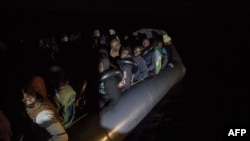 Migrants off the coast of Libya wait on an inflatable boat for rescue by the nongovernmental organization Proactiva Open Arms.