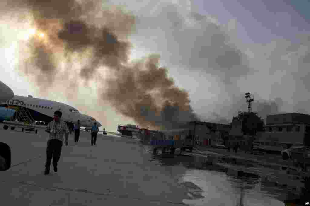 Smoke rises above the Jinnah International Airport where security forces battled militants, Karachi, Pakistan, June 9, 2014.