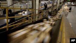 FILE - FedEx packages move on a conveyor belt at the FedEx hub at Los Angeles International Airport in Los Angeles.