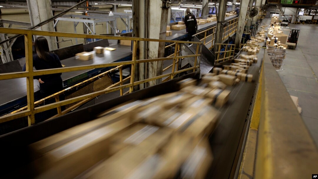 FILE - FedEx packages move on a conveyor belt at the FedEx hub at Los Angeles International Airport in Los Angeles.