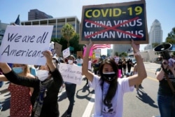 Protesters march against anti-Asian hate crimes past the Los Angeles Federal Building, March 27, 2021. The crowd demanded justice for the victims of the Atlanta spa shootings and for an end to racism, xenophobia and misogyny.