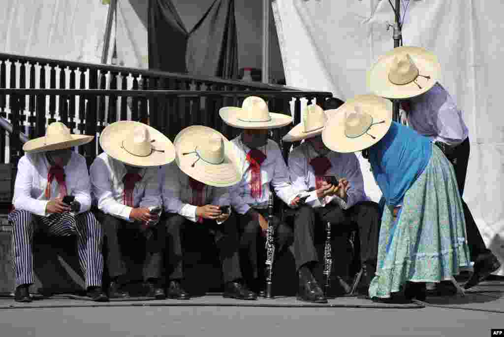 People wait to perform in a parade marking the 109th anniversary of the Mexican Revolution in Mexico City, Nov. 20, 2019.