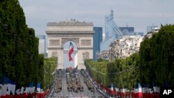 FILE - Troops march down the Champs Elysees avenue in Paris, France, as part of Bastille Day parade Tuesday, July 14, 2015. 