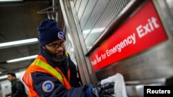 MTA worker disinfects a subway station in the Manhattan borough of New York City, March 4, 2020. 