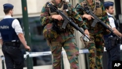 FILE - Belgian Army soldiers patrol during a court hearing for suspect Mohamed Abrini, a suspect in the Paris and Brussels attacks, that were claimed by the Islamic State organization, at the Court of Appeals in Brussels. 