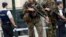 FILE - Belgian Army soldiers patrol during a court hearing for suspect Mohamed Abrini, a suspect in the Paris and Brussels attacks, that were claimed by the Islamic State organization, at the Court of Appeals in Brussels. 