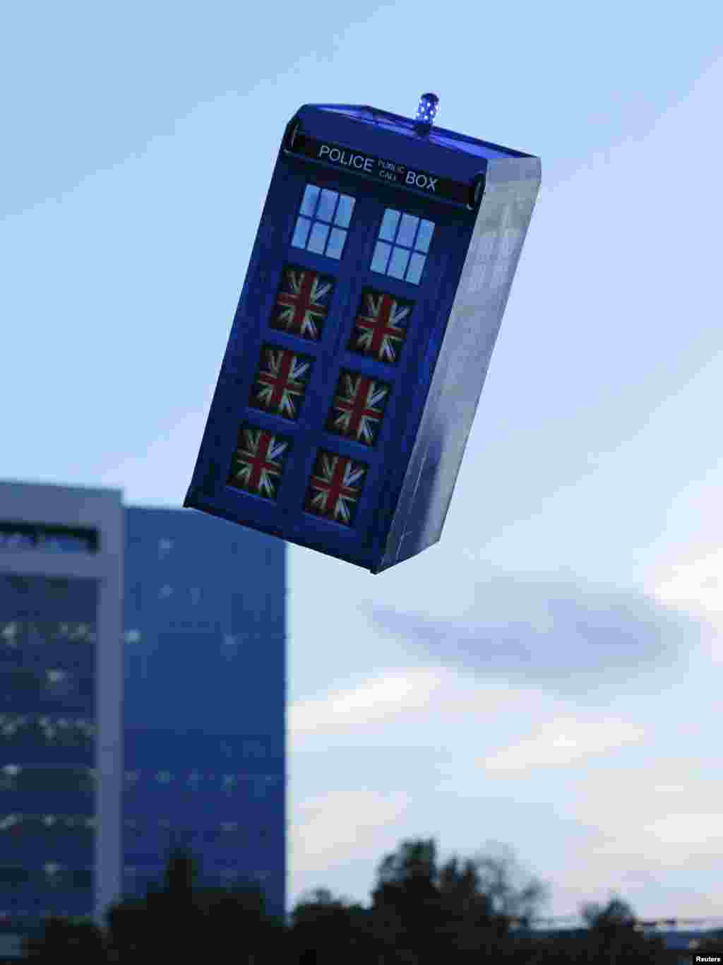 A flying "Tardis" remote control air craft is test-flown past a building in San Diego, California, Nov. 18, 2013. Inventor Otto Dieffenbach built the "Tardis", an old-fashioned police call box used as a time machine in the British television series Dr. Who, to celebrate the show's 50th season this year.