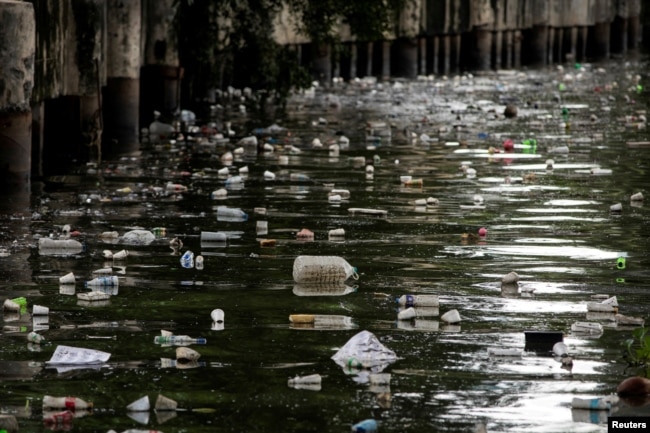 FILE - Plastic bottles float on the heavily polluted San Juan River, a tributary of Pasig River in Mandaluyong City, Philippines, June 21, 2021. (REUTERS/Eloisa Lopez/File Photo)