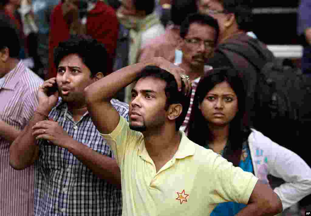 People stand watching outside a hospital after it caught fire in Kolkata. (AP/Bikas Das)