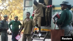 FILE - Opposition supporters arrested for violent protests arrive to submit bail applications at the Harare Magistrates Courts, in Harare, Zimbabwe, August 7,2018.