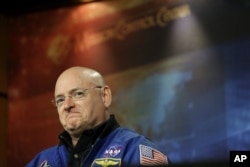 FILE - NASA astronaut Scott Kelly listens to a question about his scheduled mission aboard the International Space Station during a briefing at Johnson Space Center in Houston, Dec. 5, 2012.