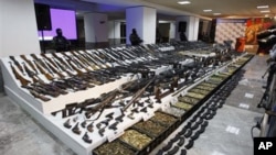 Soldiers stand guard during a presentation of weapons seized during an operation against the Gulf cartel in Mexico City, (File).