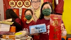 民主黨前中西區區議員伍凱欣手持林卓廷寫的揮春，以及民主黨地區組織”解圍”設計的口罩。 (美國之音 湯惠芸)