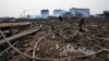 Relatives look for a missing worker at the pesticide plant owned by Tianjiayi Chemical following an explosion, in Xiangshui county, Yancheng, Jiangsu province, China, March 23, 2019.