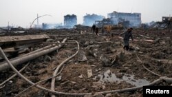 Relatives look for a missing worker at the pesticide plant owned by Tianjiayi Chemical following an explosion, in Xiangshui county, Yancheng, Jiangsu province, China, March 23, 2019.