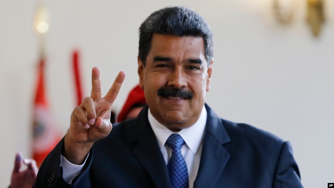 Venezuela's President Nicolas Maduro makes the victory sign after a meeting with former Spanish Prime Minister Jose Luis Rodriguez Zapatero at the presidential palace in Caracas, Venezuela, May 18, 2018. Maduro is seeking a new six-year mandate and, despite crippling hyperinflation and widespread shortages of food and medicine, he is widely expected to win it Sunday.