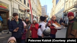 Patsunee Kubiak (center), a Thai housewife and her Polish husband Patryk Kubiak (second from right) bring a Ukrainian family, consisting of parents and their three children, to Warsaw Old Town in Warsaw, Poland