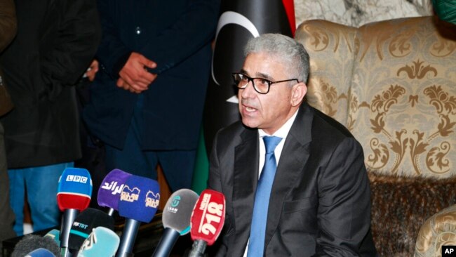 FILE - Fathi Bashagha talks to reporters after east-based lawmakers named him to replace then-Prime Minister Abdul Hamid Dbeibah as head of a new interim government, in Tripoli, Libya, Feb. 10, 2022.