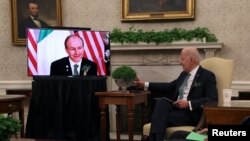 FILE - U.S. President Joe Biden participates in a bilateral videoconference with Ireland's Prime Minister Micheal Martin in the Oval Office at the White House in Washington, March 17, 2021. 