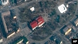 FILE - This satellite image provided by Maxar Technologies shows the Mariupol Drama Theater in Mariupol, March 14, 2022.