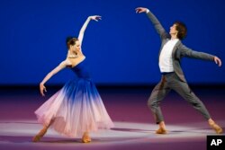 FILE - Bolshoi Ballet soloists and Benois de la Danse laureates Olga Smirnova and Semion Chudin perform the Adagio from the Taming of the Shrew, during a Nominees Gala Concert in the Bolshoi Theater in Moscow, Russia, May 26, 2015.