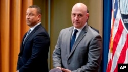 U.S. Attorney Breon Peace, left, and Alan Kohler Jr., assistant director of the FBI's Counterintelligence Division, arrive at a news conference at the Justice Department in Washington, March 16, 2022, to discuss recent law enforcement actions to address transnational repression.