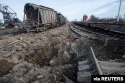 FILE - A view shows a bomb crater after an air strike, as Russia's attack on Ukraine continues, at a railway station in the town of Okhtyrka, in the Sumy region, Ukraine, March 14, 2022.