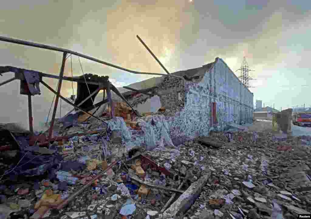 A warehouse is seen on fire after Russian shelling in Kharkiv, March 16, 2022.