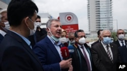 Turkish academicians, lawyers, politicians and representatives of Uyghur NGOs protest outside the Justice Ministry against a Turkish court decision that denied a Uyghur leader's entry in Turkey and China's alleged oppression against Uyghurs, in Ankara, June 8, 2021.