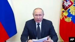 In this photo taken from video released by the Russian Presidential Press Service, Russian President Vladimir Putin speaks during a meeting via videoconference at the Novo-Ogaryovo residence outside Moscow, March 16, 2022. (Russian Presidential Press Service via AP)