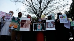 Indians hold placards during a protest against banning Muslim girls wearing hijab from attending classes at some schools in the southern Indian state of Karnataka, in Bengaluru, Karnataka state, India, Feb. 19, 2022.