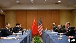 In this photo released by Xinhua News Agency, Yang Jiechi, a member of the Political Bureau of the Communist Party of China Central Committee, (left) meets with US National Security Advisor Jake Sullivan (right) in Rome, March 14, 2022.