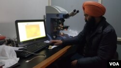 A technician checks the quality of a Pashmina shawl before GI tagging at Kashmir Handicraft Center of the Craft Development Institute. (Bilal Hussain/VOA)