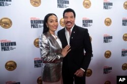 Lionel Richie dan pacarnya Lisa Parigi, tiba di karpet merah Konser Penghormatan Penghargaan Gershwin Prize 2022 di DAR Constitution Hall, Washington, Rabu, 9 Maret 2022. (Foto AP/Kevin Wolf)