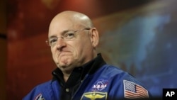 FILE - NASA astronaut Scott Kelly listens to a question about his scheduled mission aboard the International Space Station during a briefing at Johnson Space Center in Houston, Dec. 5, 2012.