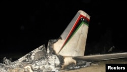 The wreckage of a Libyan military plane is seen in Grombalia town, south of Tunis, February 21, 2014.