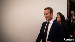 Facebook Chief Executive Mark Zuckerberg walks past members of the news media between meetings with lawmakers on Capitol Hill in Washington, Sept. 19, 2019. 