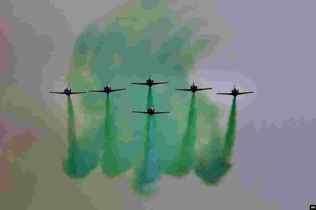 Pakistan Air Force jets demonstrate an aerobatic performance during a military parade to mark Pakistan National Day in Islamabad.