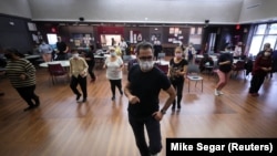 Walter Perez teaches a seniors dance class at senior centers in New York City. Older adults can socialize, stay fit, and enjoy the music during the coronavirus (COVID-19) pandemic, March 7, 2022. (Reuters Mike Segar)