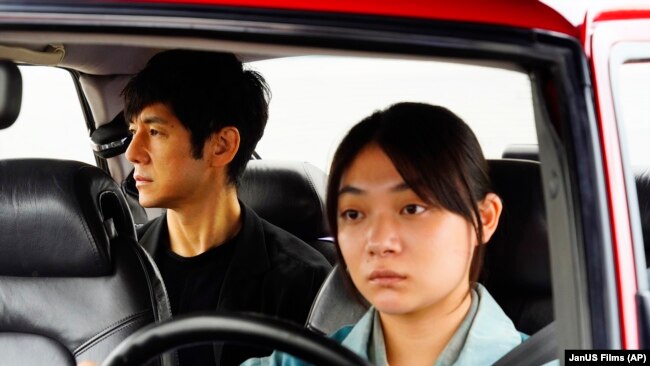 This image released by Janus Films and Sideshow shows Hidetoshi Nishijima, left, and Toko Miura in a scene from "Drive My Car."