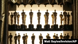 FILE - Oscar statuettes appear backstage at the Oscars at the Dolby Theatre in Los Angeles, Feb. 28, 2016. 