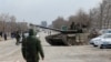 Service members of pro-Russian troops are seen atop of a tank on the outskirts of the besieged southern port city of Mariupol, Ukraine, March 20, 2022.