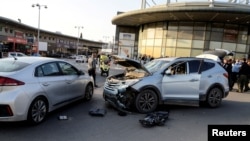 The wreckage of a car stands at an intersection after an assailant crashed into another vehicle, in Beersheba, Israel, March 22, 2022. 