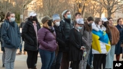 FILE - Photo provided by the University of Rhode Island. Students gather at a peace vigil for Ukraine hosted by the University of Rhode Island Chaplains Association and the Center for Nonviolence and Peace Studies in Kingston, R.I., March 3, 2022.