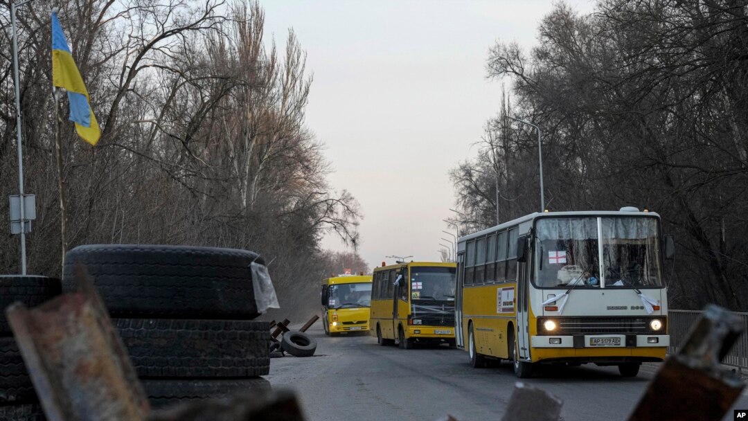 Evacuation buses carrying internally displaced people arrive at an IDP center in Zaporizhzhia, Ukraine, March 25, 2022.