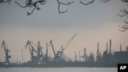 FILE - Harbor cranes are seen at the trade port in Mariupol, Ukraine, Feb. 23, 2022. Ukrainian ports in the Black Sea are major hubs for wheat and corn, but traffic in and out has ground to a halt due to Russia's invasion of Ukraine.