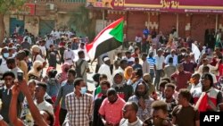 Sudanese protesters march during a demonstration calling for civilian rule and denouncing the military administration, in the capital Khartoum's twin city of Umdurman, on Feb. 14, 2022. 