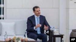 FILE -This photo released by the official Facebook page of the Syrian presidency, shows Syrian President Bashar Assad, in Abu Dhabi, United Arab Emirates, March 18, 2022.