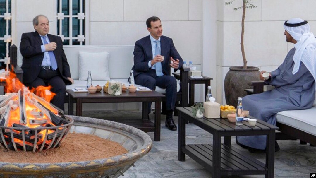 In this photo from the Facebook page of the Syrian presidency, Syrian President Bashar Assad, center, and Syrian Foreign Minister Faisal Mekdad, left, meet with Abu Dhabi's Crown Prince, Sheikh Mohammed bin Zayed Al Nahyan, in Abu Dhabi, United Arab Emirates, March 18, 2022.